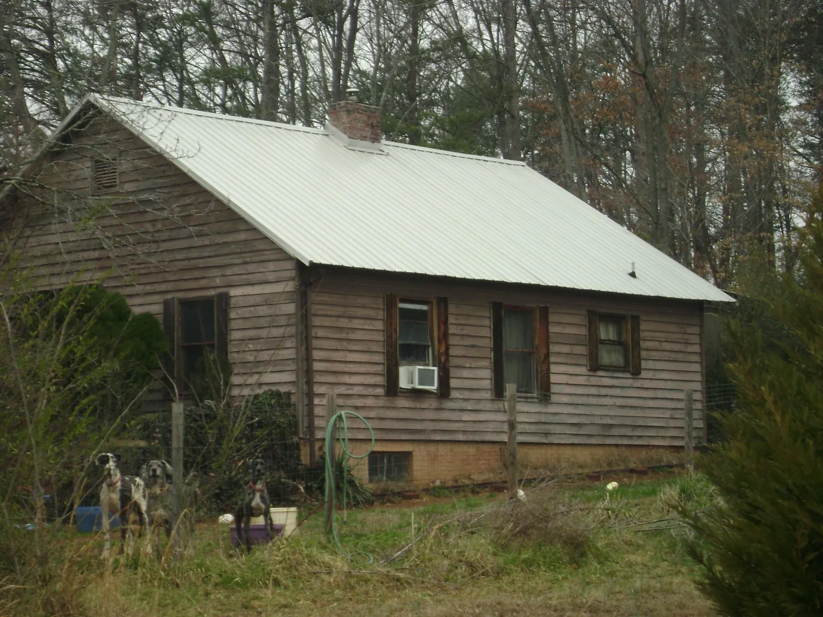 White metal roof on an old wood sided farmhouse, from a Metal Roof Installation job in Brewster